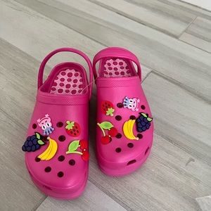 Croc-inspired platform sandals with charms